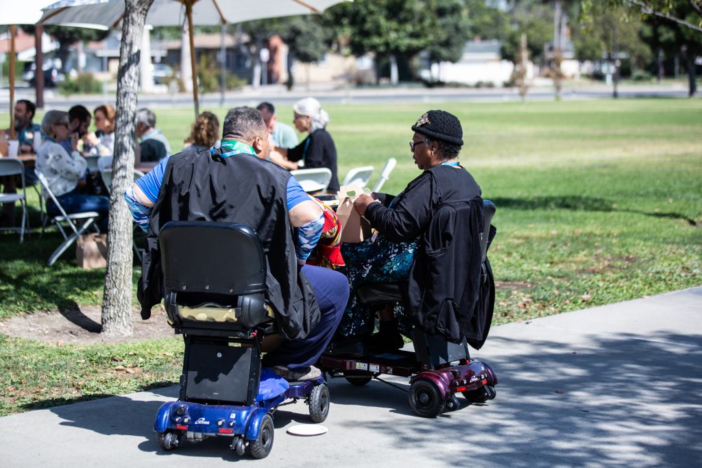 Attendees in scooters enjoy lunch al fresco