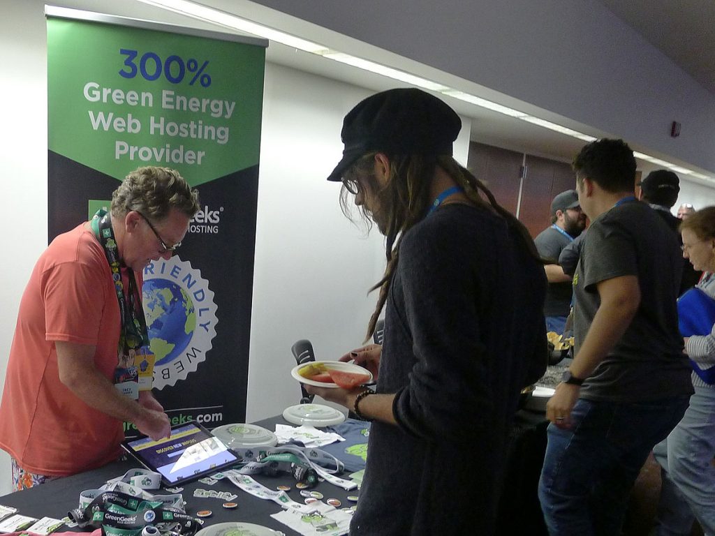 Attendees visit the GreenGeeks table
